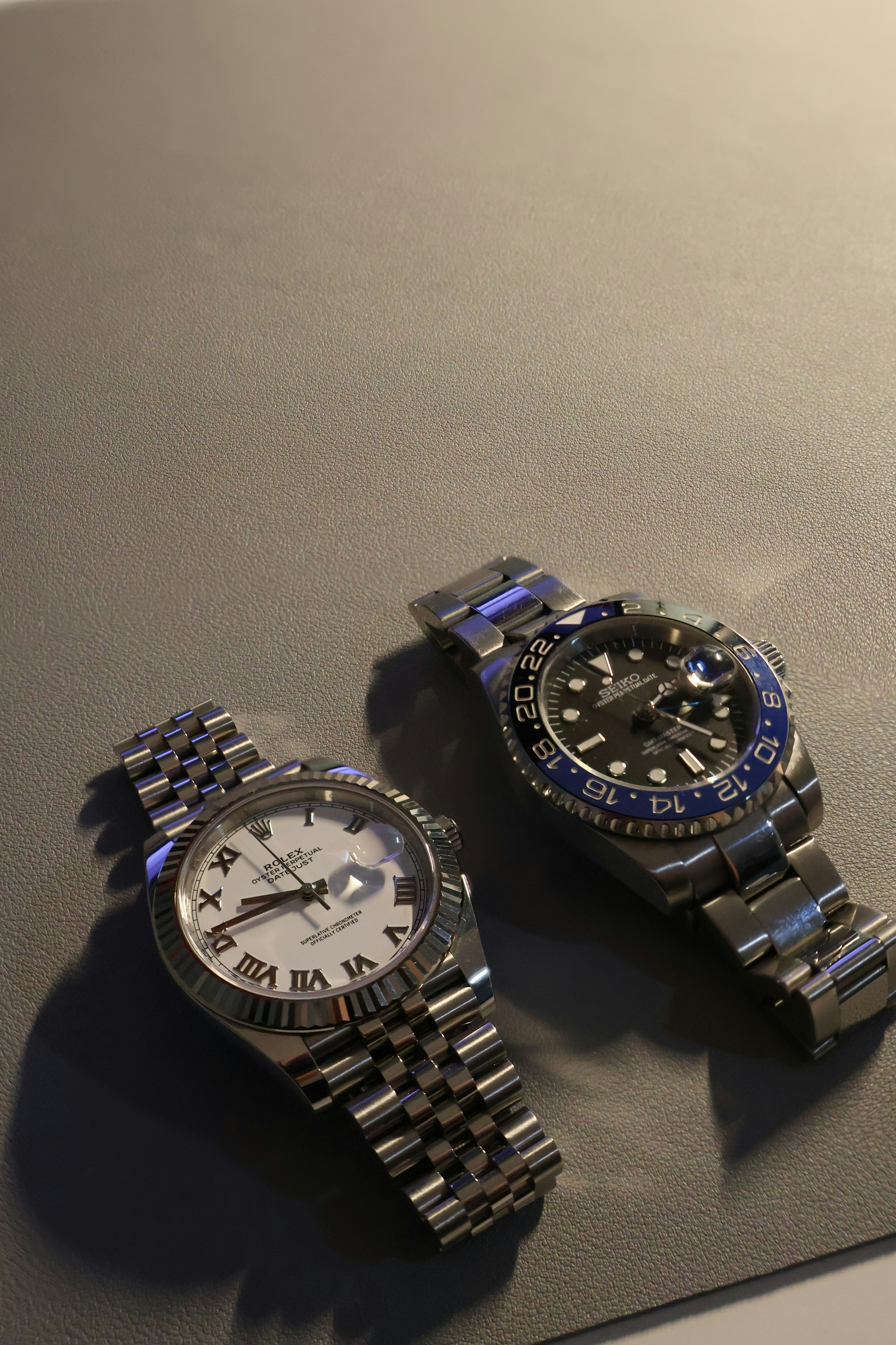 Luxury Rolex watches on leather surface showcasing premium timepieces